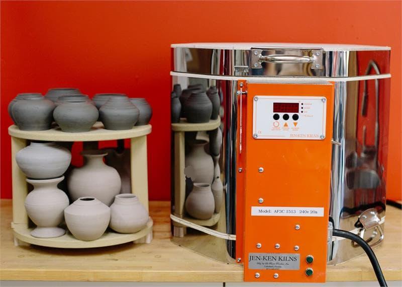 Jen-Ken Kilns 1513 "The Emerge" kiln next to a furniture kit with unfired pottery on shelves