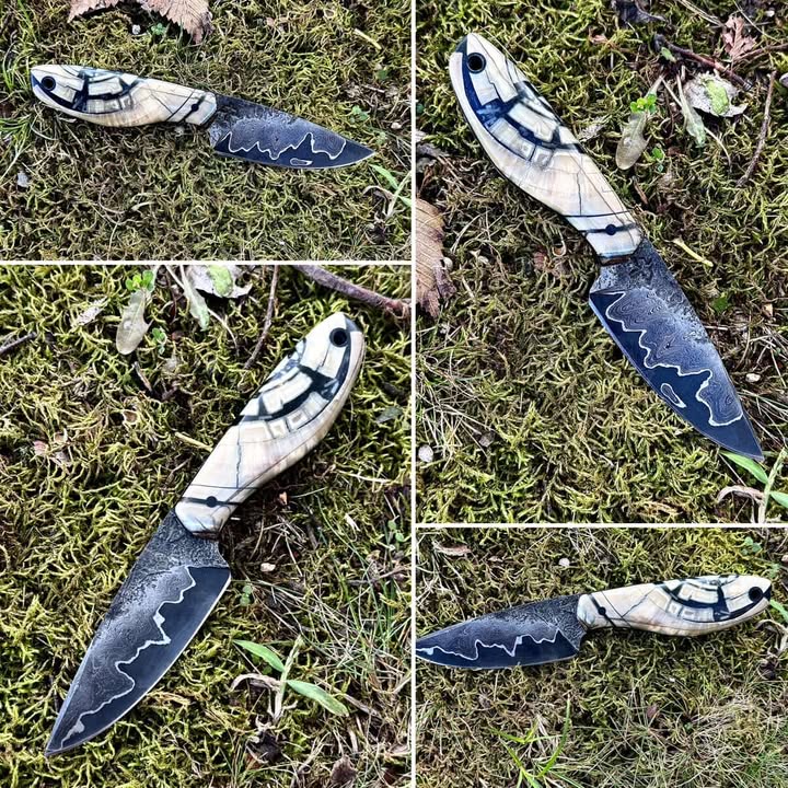 Handcrafted knife by Vince of Black Bird Blades displayed on forest moss, featuring a high-contrast etched steel blade and light-colored sculpted handle with dark accent lines; heat treated using a Jen-Ken kiln.