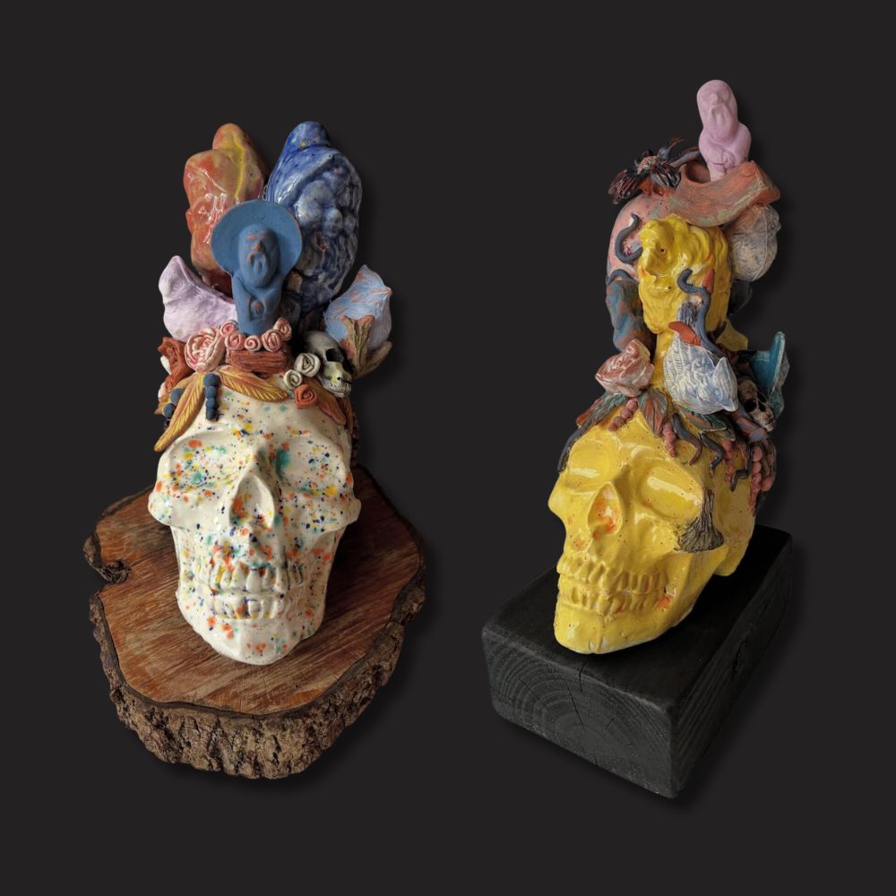 Ceramic assemblage sculptures by Pickled Aliens Pottery featuring skull forms topped with layered slip-cast and hand-sculpted figures, exploring balance and imagination; fired to cone 5/6 in a Jen-Ken electric kiln.